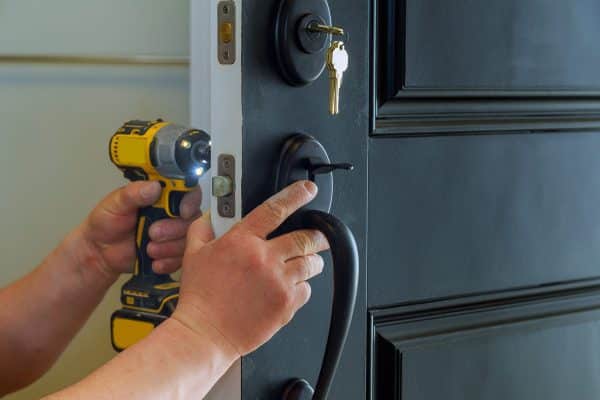 Installing new lock on exterior front door to home. Residential Locksmith Aurora, CO - BS Locksmith