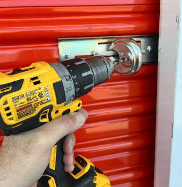 Drilling out a padlock on a storage unit because the customer lost their key to it.