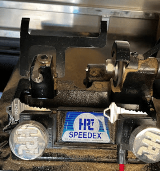 key cutter duplicating a key for a door lock