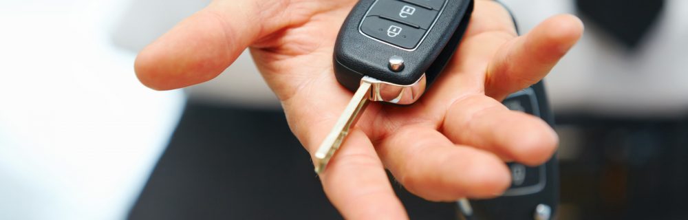 Car Keys. Seller hand giving keys